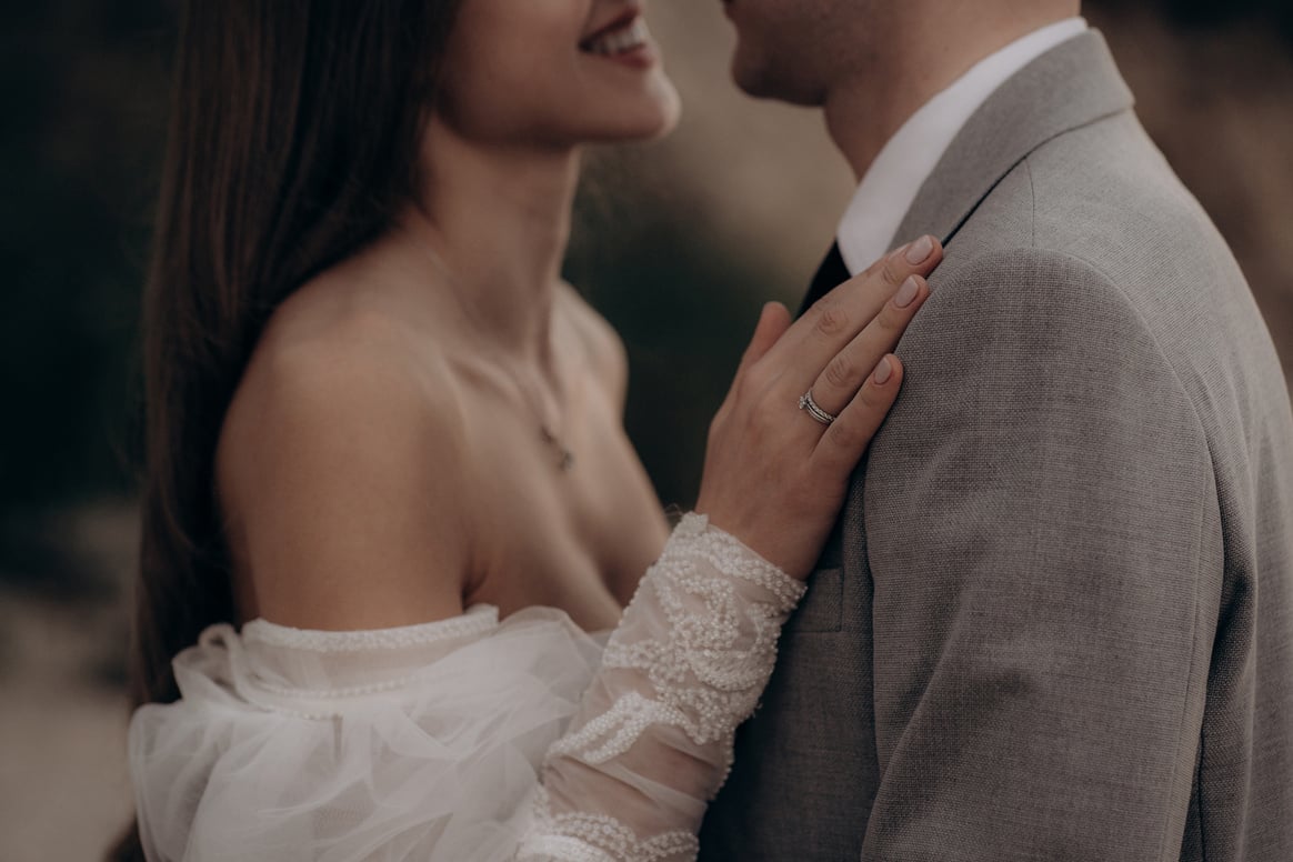 Happy couple having photoshoot outdoors, kissing.